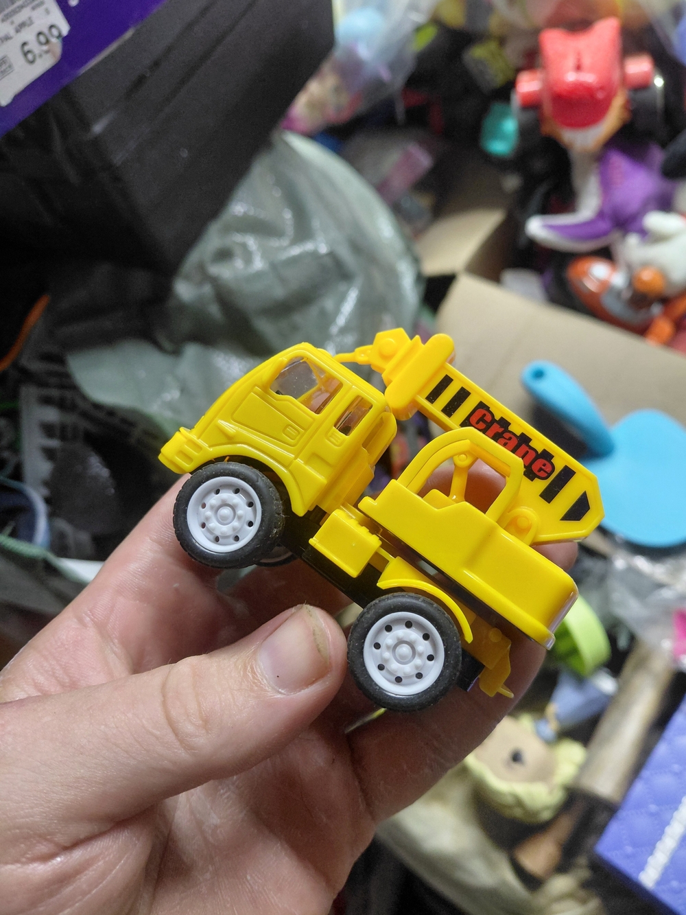 small yellow toy crane truck from the WowToyz Construction Vehicles Backpack Pla